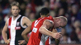 Swans skipper Barry Hall roughs up Matt Maguire at the MCG