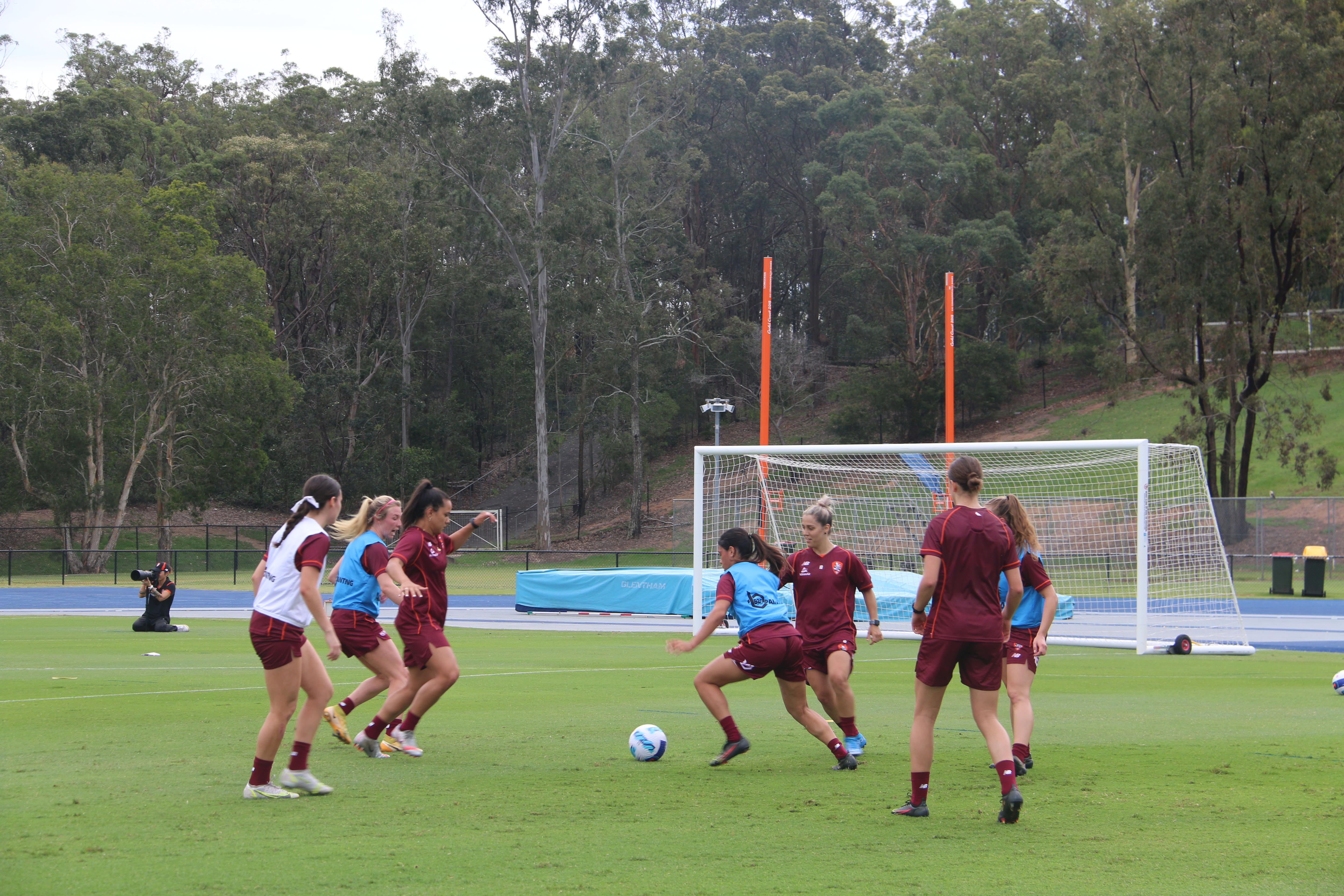 Women play football on an oval