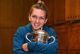 Romania's Simona Halep hugs the trophy for the French Open in the dressing room