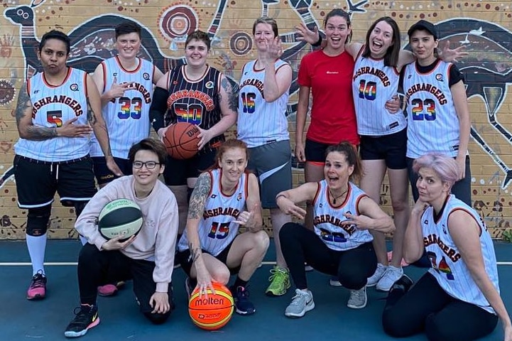 Team members of the Bushrangers Basketball squad smile at the camera.