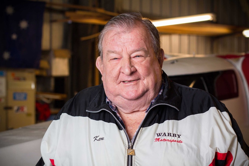 Ken Warby stands in a shed.