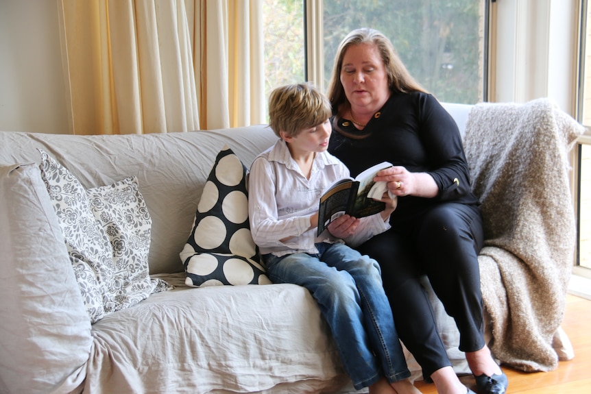 Karen van Gorp reads with one of her sons.
