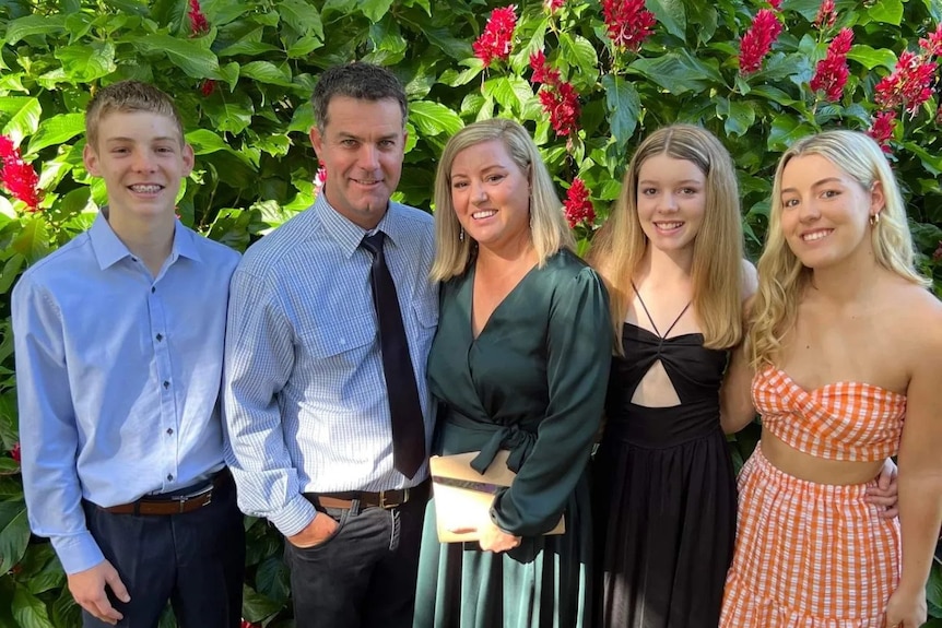 A woman, man, teenage boy and two girls dressed up