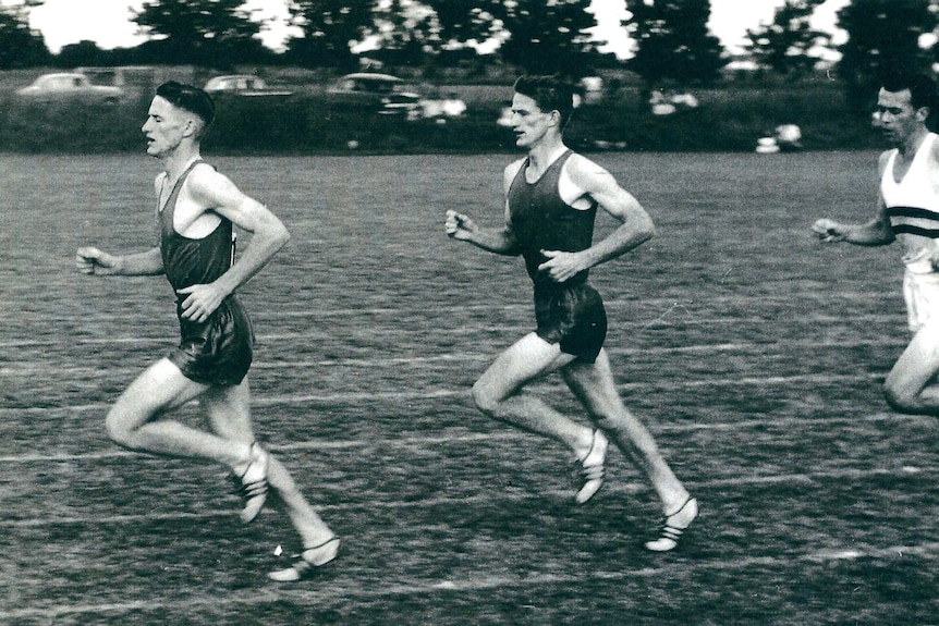 Black and white photo of Keith Pearce running with his twin brother, aged in their twenties.