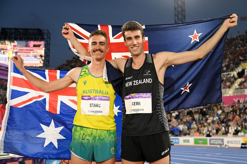 Australia's Brandon Starc and New Zealand's Hamish Kerr hold up their flags after the Commonwealth Games high jump final.