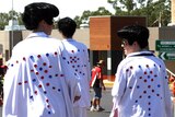 A group of impersonators strut their stuff on stilts at the Parkes Elvis Festival