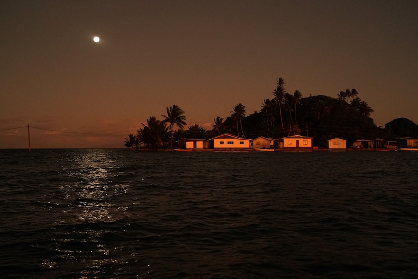 The moon rises over the island of Fiji
