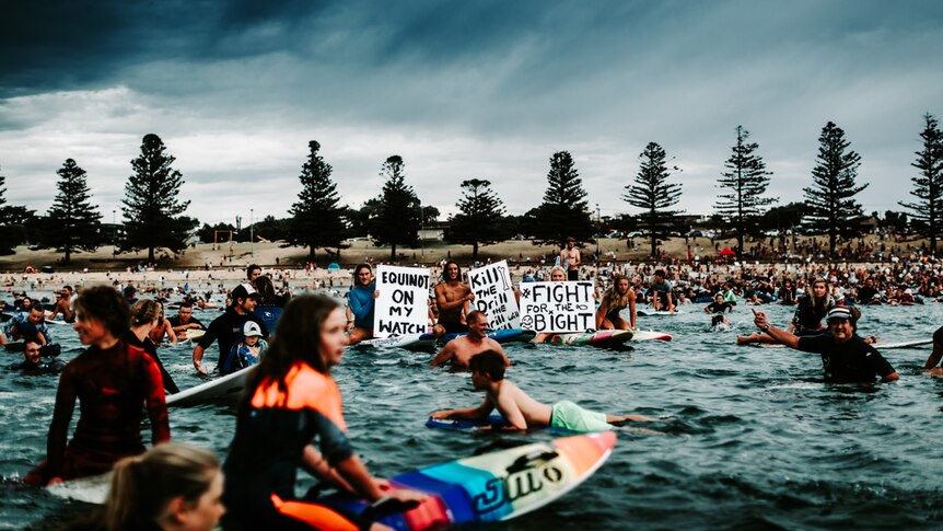 Father and son unite in the first Paddle-out protest in Torquay.