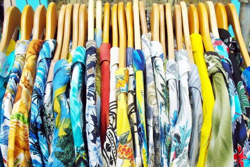 A clothes rack of colourful Hawaiian shirts.