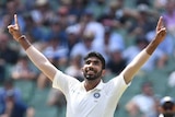 India bowler Jasprit Bumrah points both hands to the sky as he celebrates a wicket during a Test against Australia at the MCG.