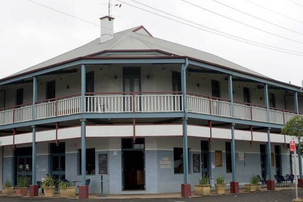 The two story Bellambi Hotel, painted white and blue, looks empty from the outside.