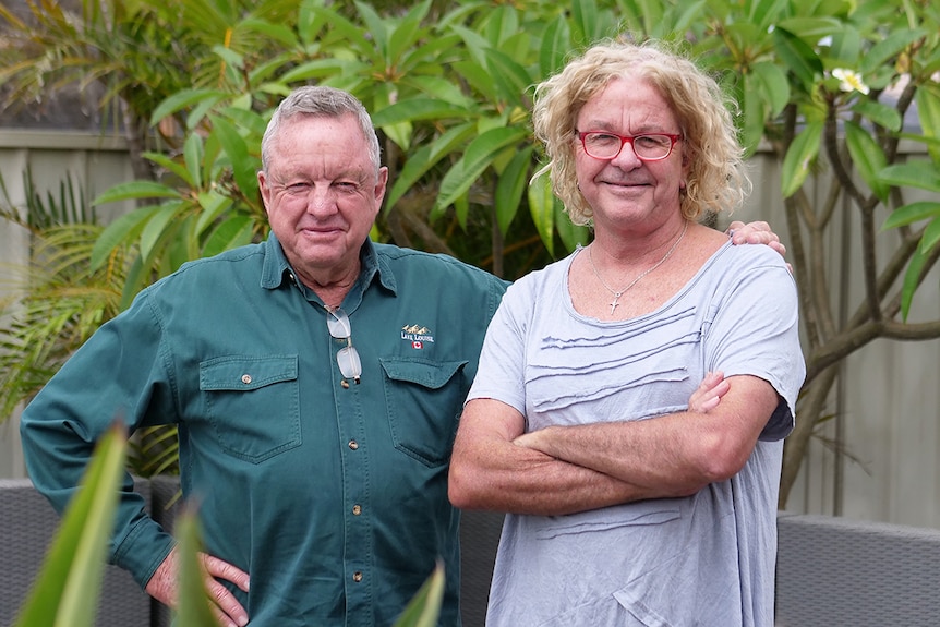 Brothers Kevin left, and Allan Barraclough right, stand side by side next to backyard pool.