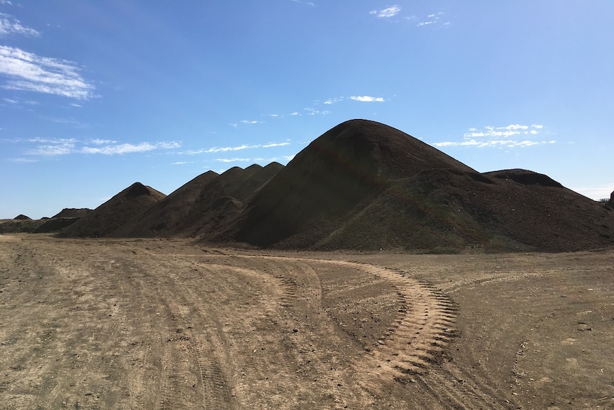 Piles of biosolids produced from a waste water treatment plant.