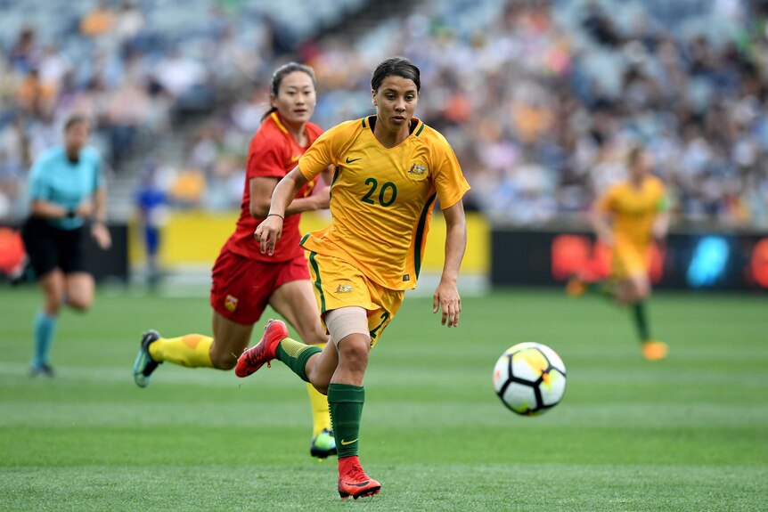 Sam Kerr chases the ball while playing for the Matildas against China.