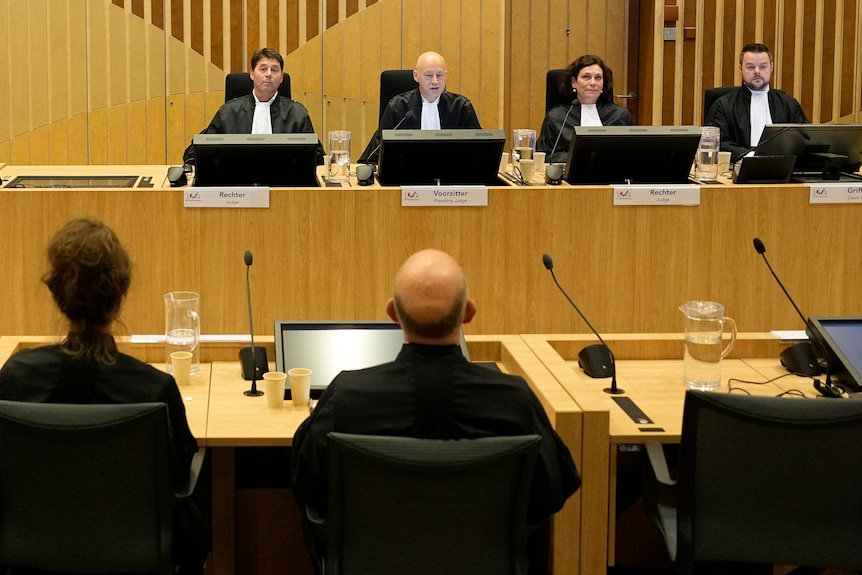 Three residing judges seated in court for the verdict of the MH17 trial.