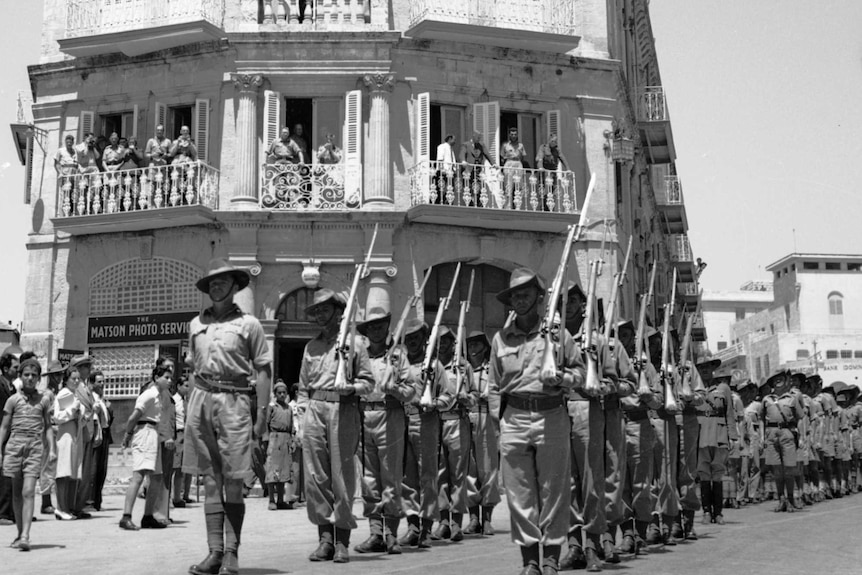 Soldiers march past the Australian Soldiers' Club in Jerusalem on Anzac Day in 1942.