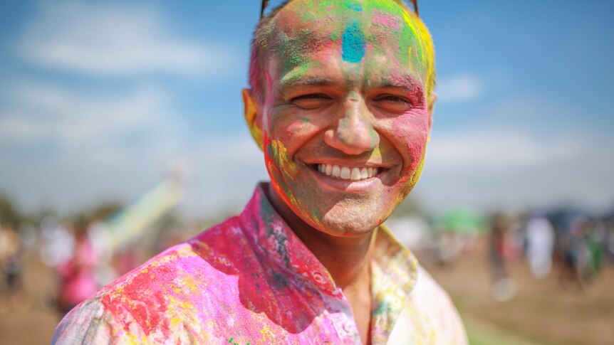 Nitin Singh covered in coloured powder