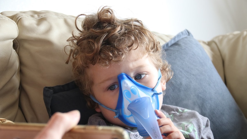 Three-year-Connor, who has cystic fibrosis, wears a breathing mask