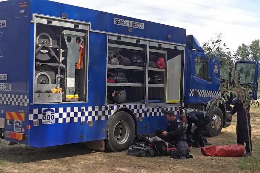 Police on the property of Karen Chetcuti on Sunday morning, where divers are searching wells.