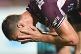 Daly Cherry-Evans holds his head in his hands