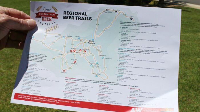 Hand holds regional beer trail map.