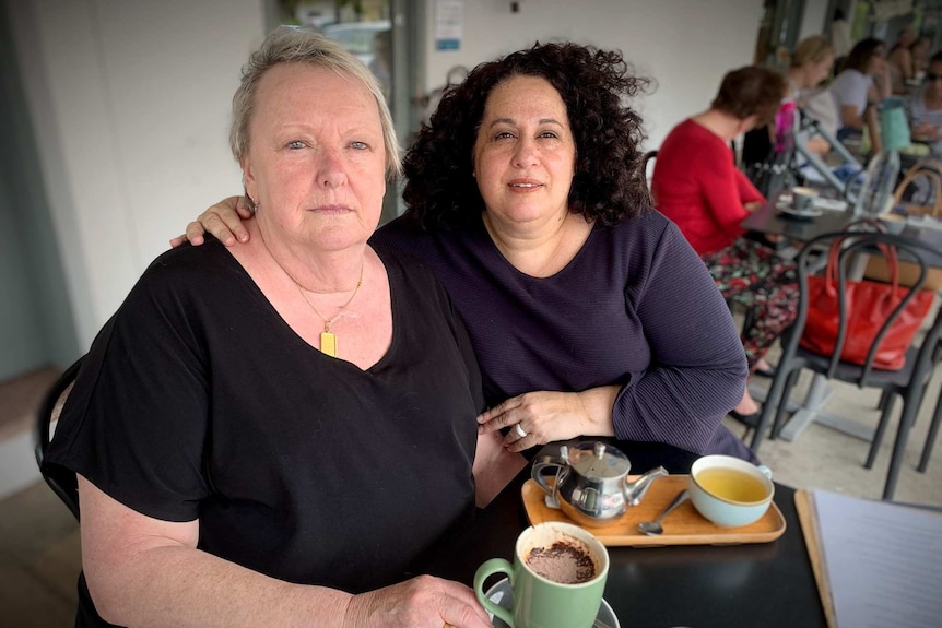 A couple sit at a cafe.