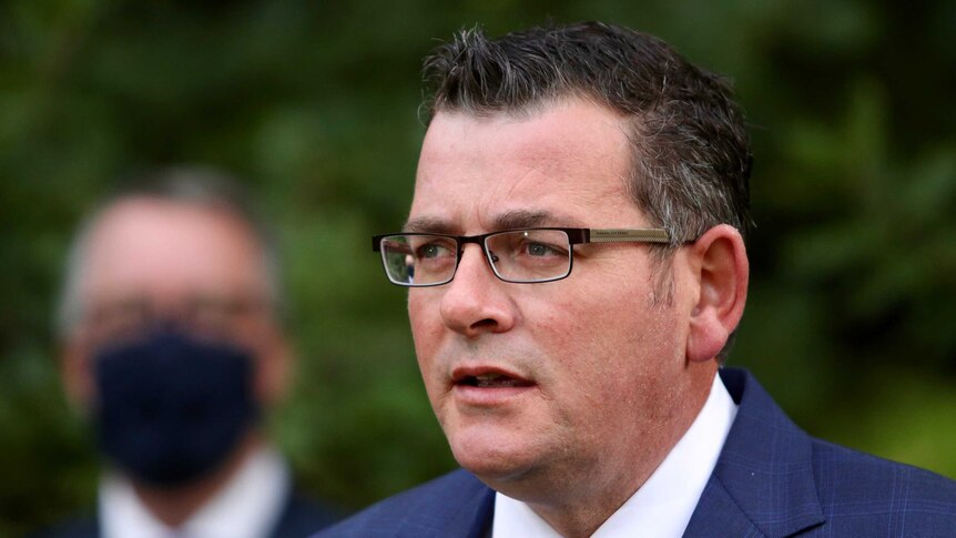 Victorian Premier Daniel Andrews speaks at a press conference outside.