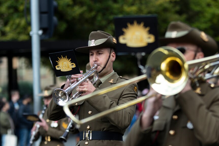 Uniformed Army musicians play brass instruments as part of Hobart's Anzac Day parade