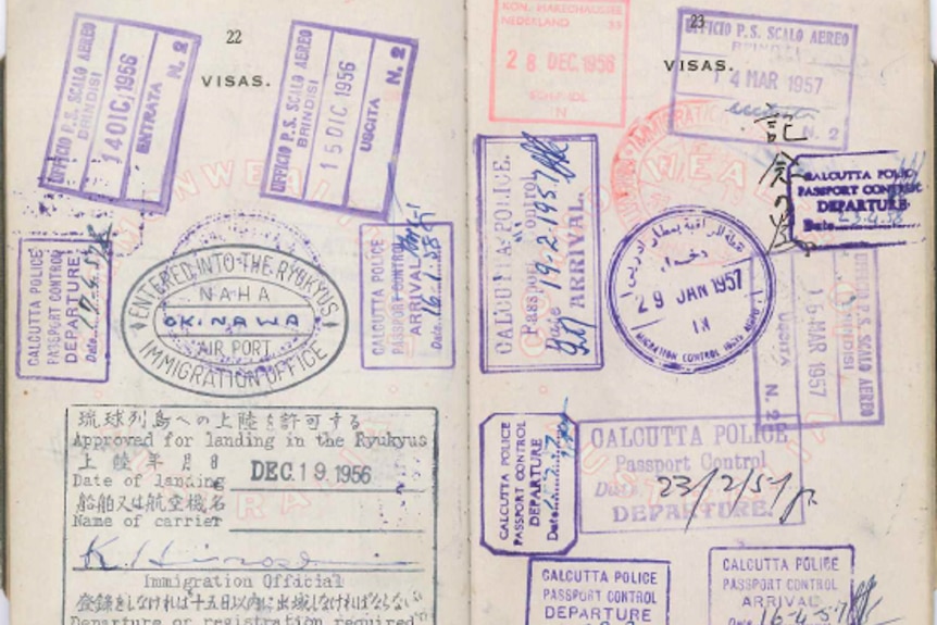 A picture of an old passport, with lots of stamps in it