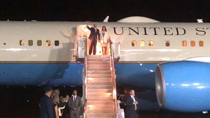 US Vice President standing at top of stairs of Air Force II waving.