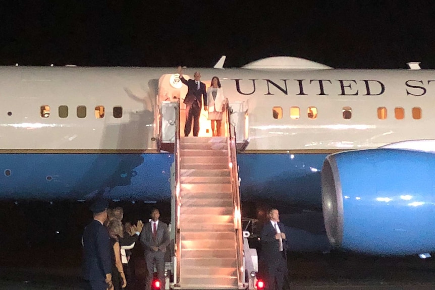 US Vice President standing at top of stairs of Air Force II waving.