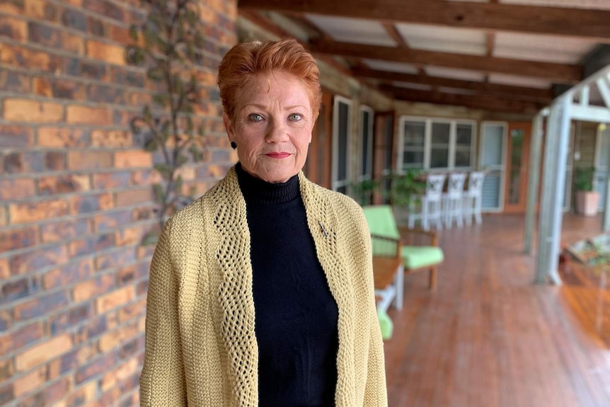 One Nation Senator Pauline Hanson stands on the verandah at her home.