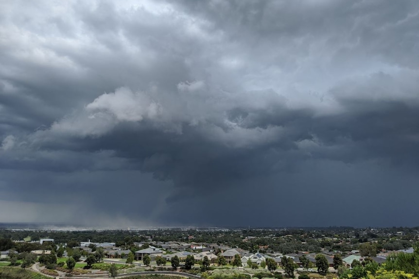 Greyish-blue clouds loom over suburban houses in Pakenham.