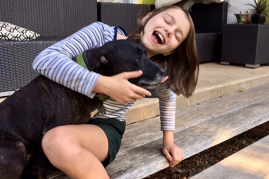 Bridgette playing with a black dog