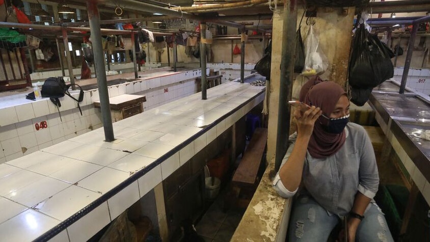 empty stalls at a wet market in Jakarta.