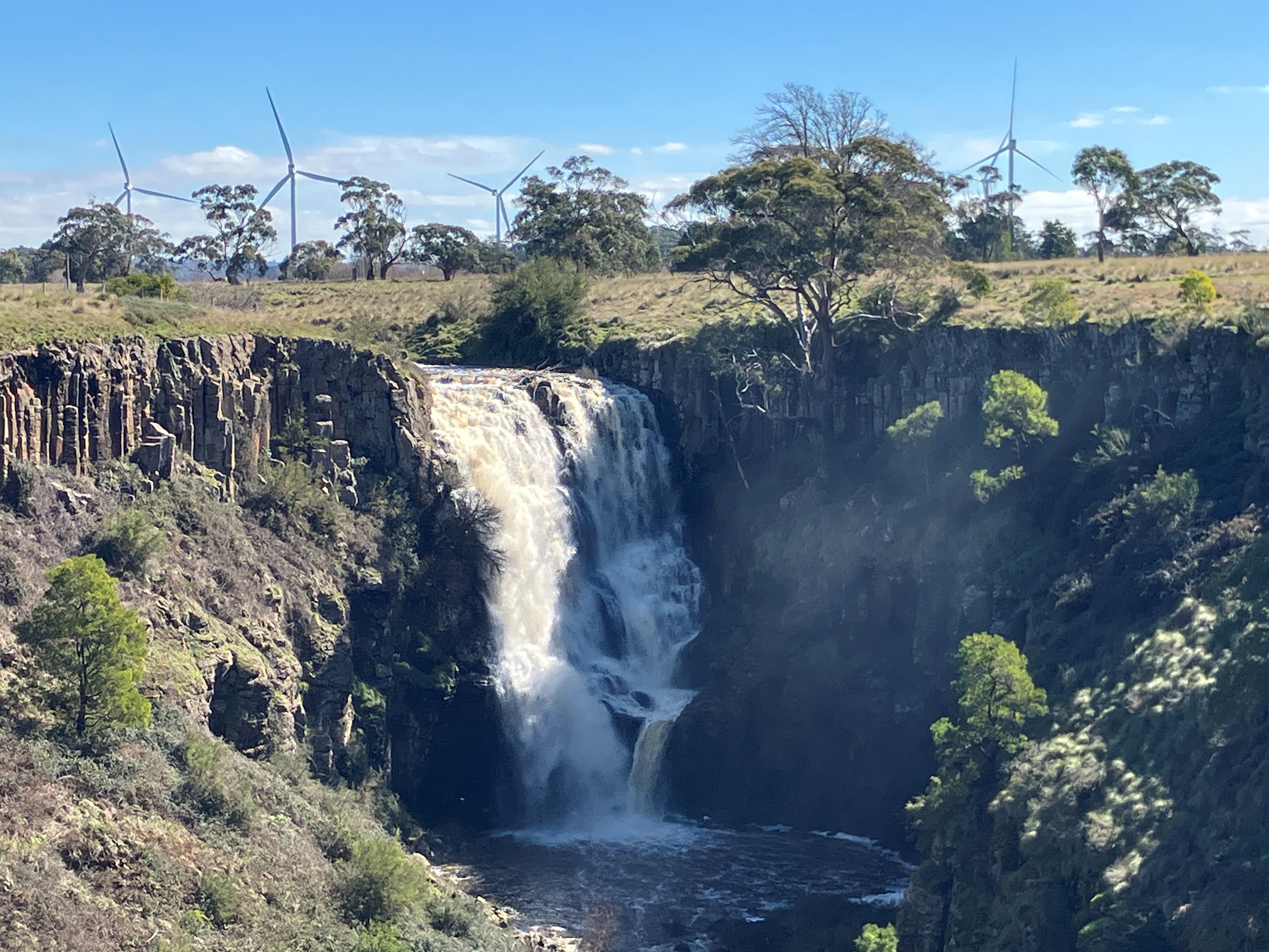 An impressive waterfall cascading from farmland into a gorge.