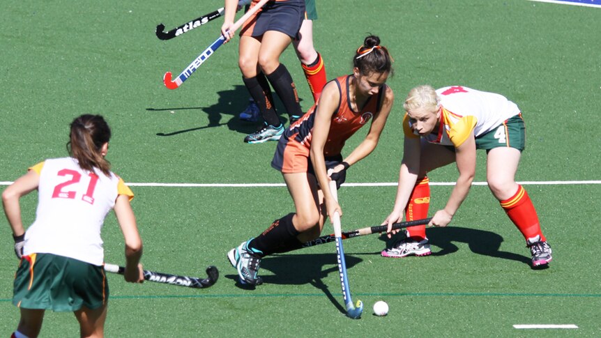 Brooke Peris controls the ball while playing hockey for the NT.