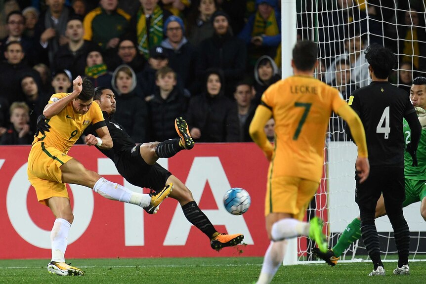 Tomi Juric's snap shot is blocked by a diving Thai defender.