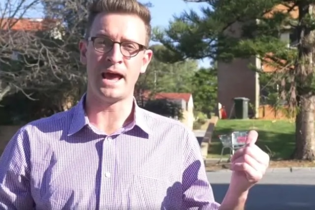 Andrew Wilson stands outside a public housing block in Mosman Park, WA.