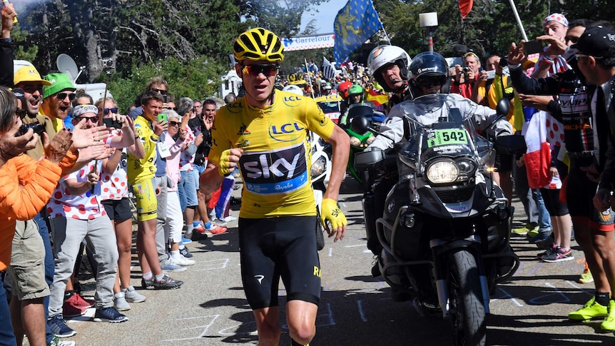 Tour de France leader Chris Froome runs on the road after a fall on Mont Ventoux on July 14, 2016.