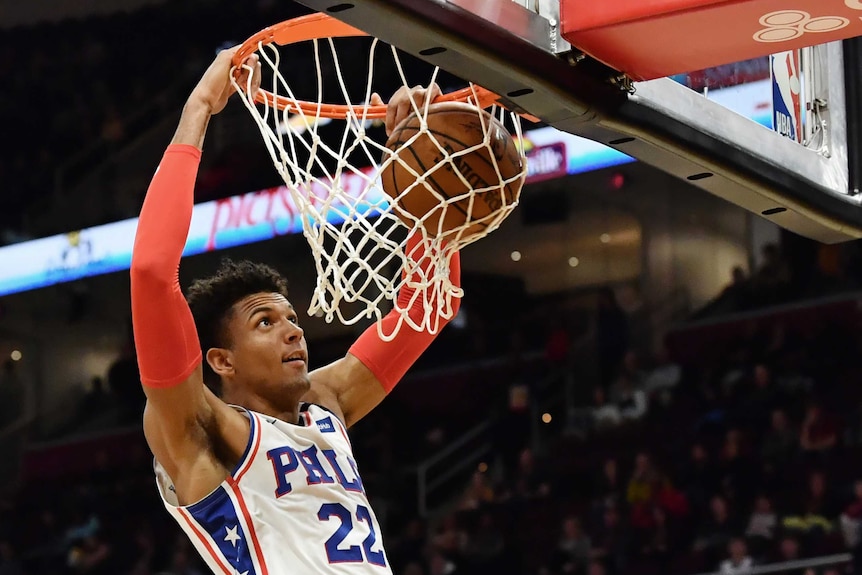 Philadelphia 76ers' Matisse Thybulle dunks a basketball with two hands.