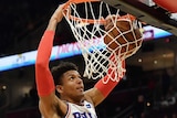 Philadelphia 76ers' Matisse Thybulle dunks a basketball with two hands.