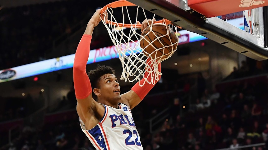 Philadelphia 76ers' Matisse Thybulle dunks a basketball with two hands.