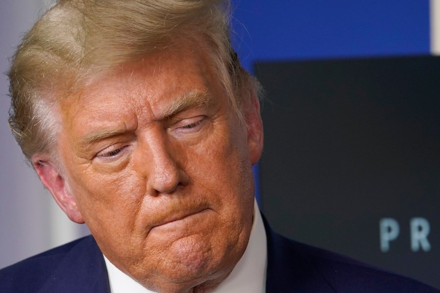 President Donald Trump listens during an event