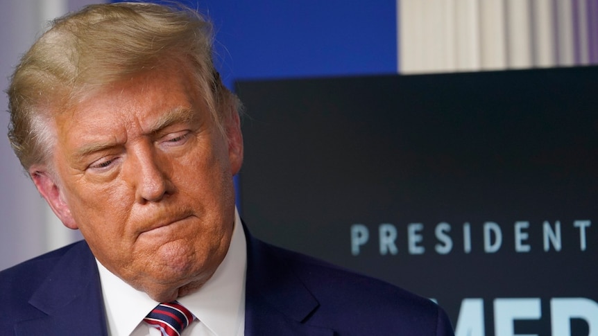 President Donald Trump listens during an event