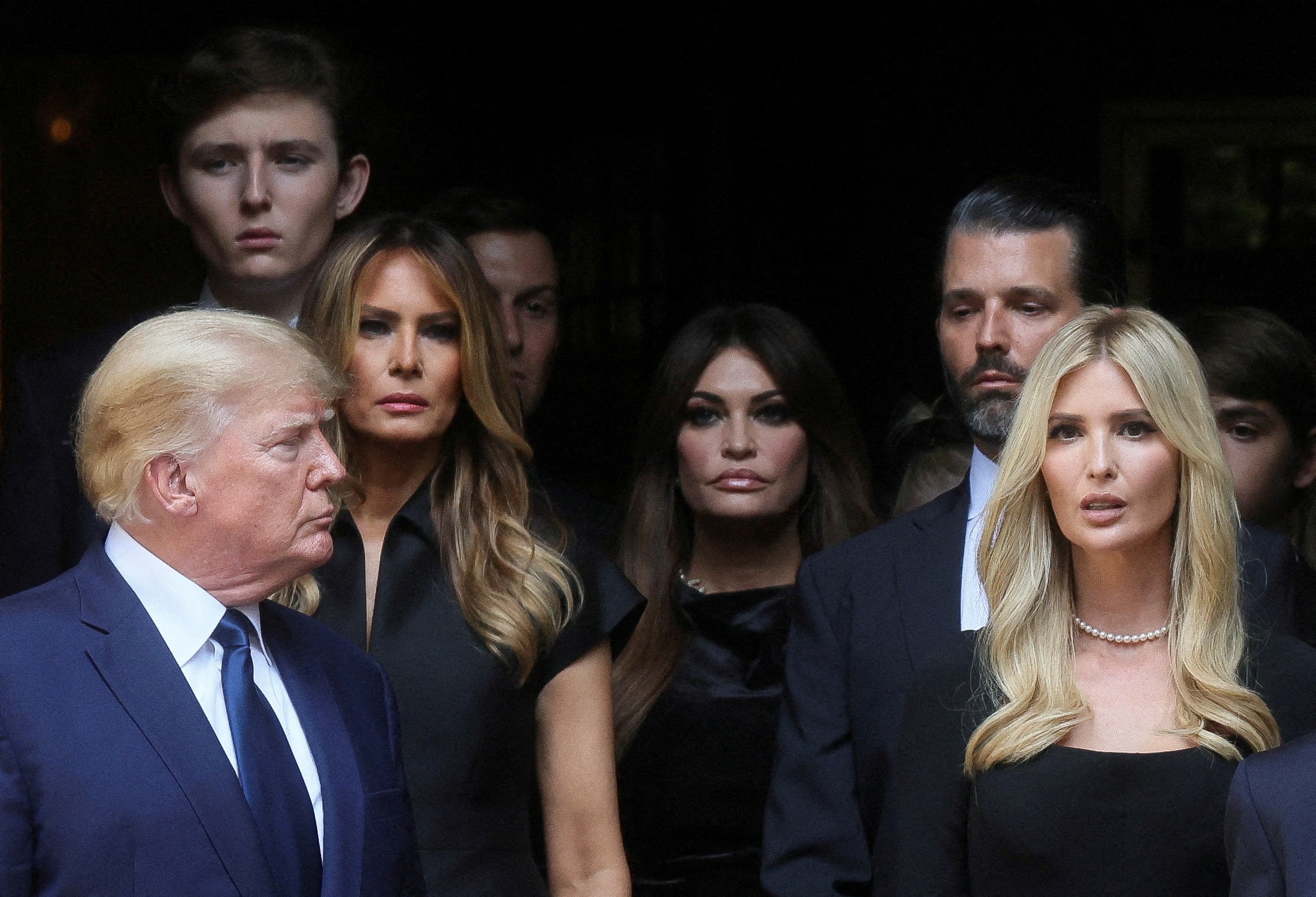Donald Trump, Ivanka Trump and Melania Trump standing in a doorway 