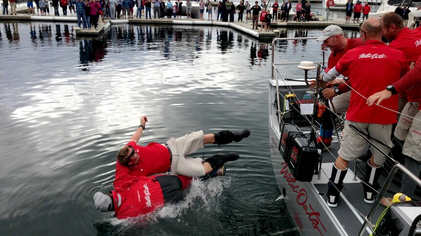 Mark Richards, bottom, is thrown into the water at Constitution Dock.