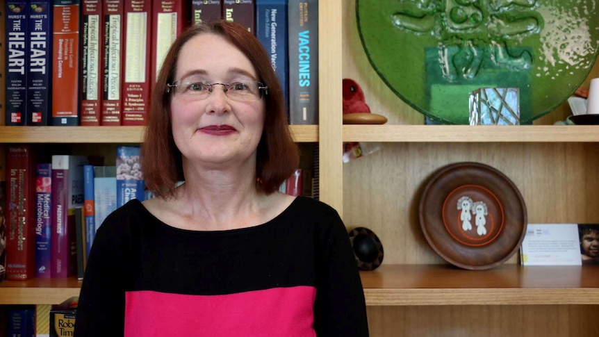 Mid shot of Dr Amanda Wilkins standing in front of a bookshelf.