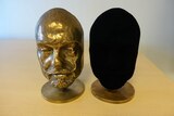 One ordinary bronze cast and another that has been coated with Vantablack that is completely black