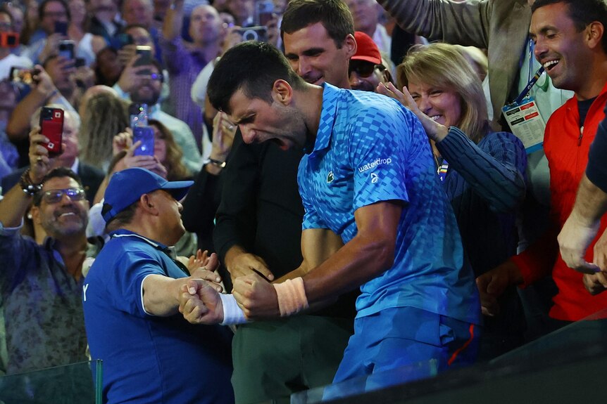 Novak Djokovic celebrates with his family and coaching staff.